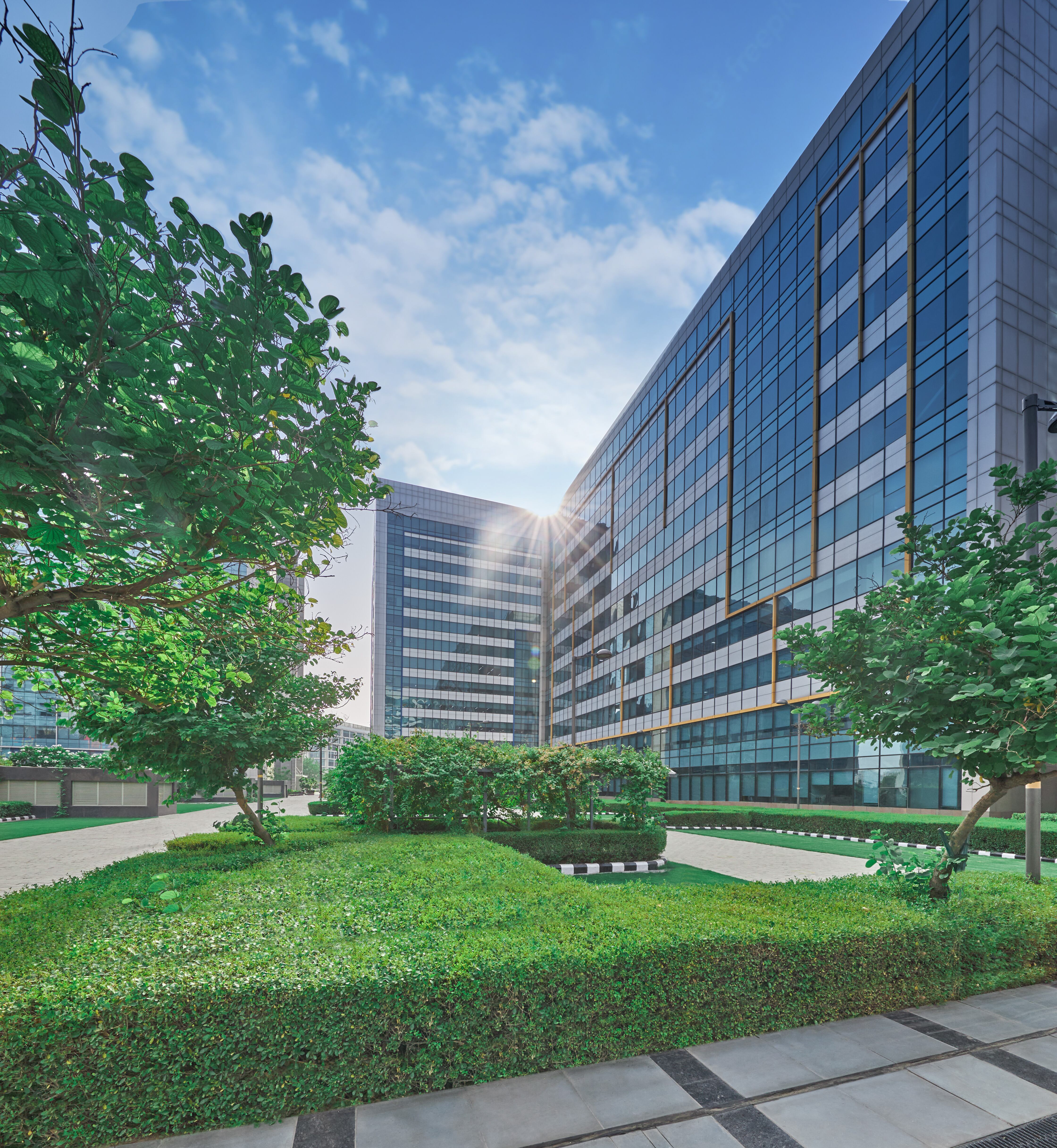 photos of a large office building with greenery in front