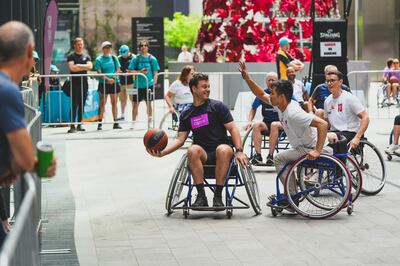 individuals in wheelchairs playing basketball