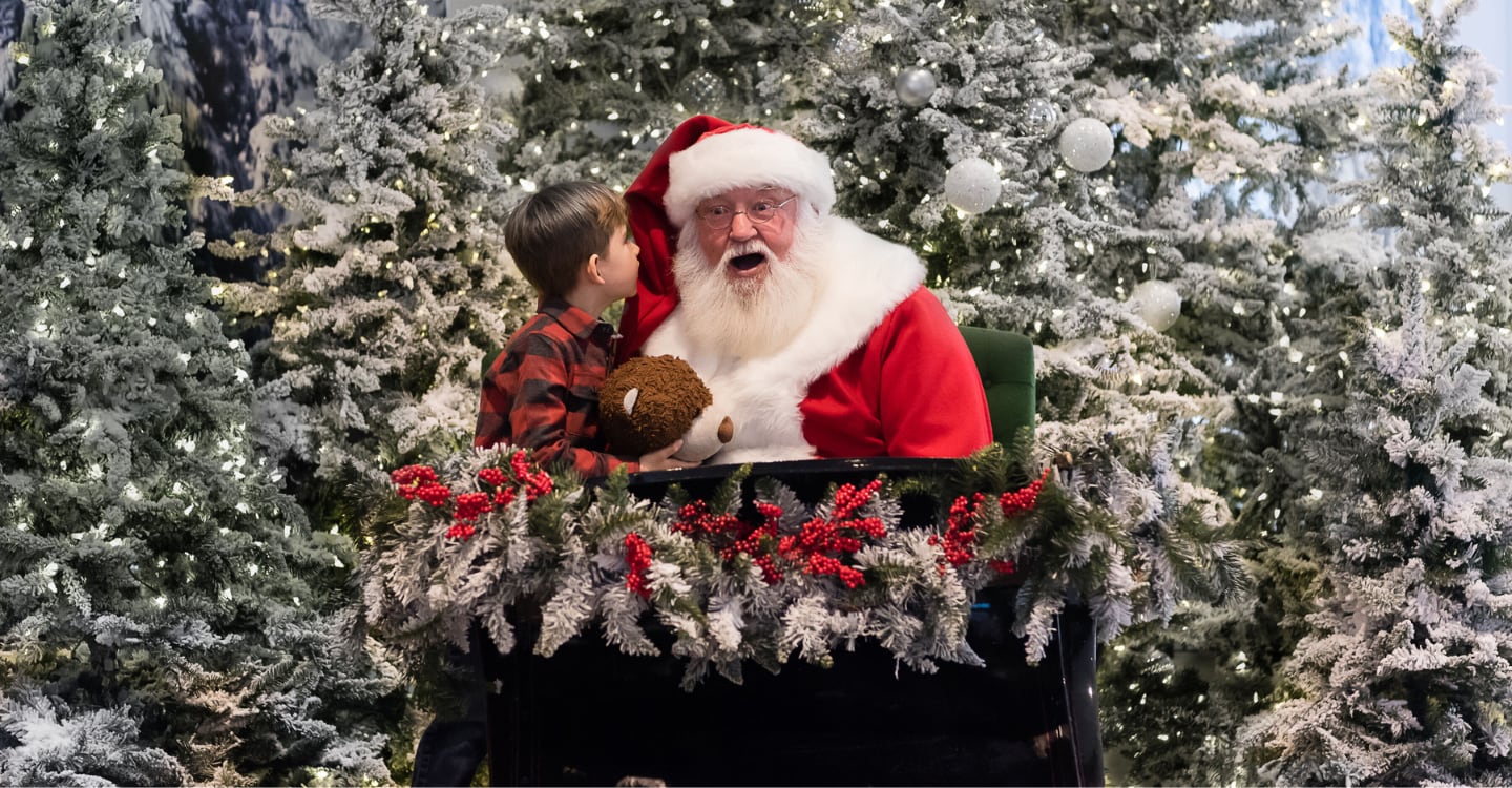 Photo of santa claus at a mall with a young customer