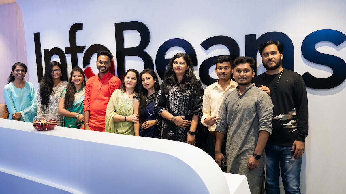 people standing in front of InfoBeans sign