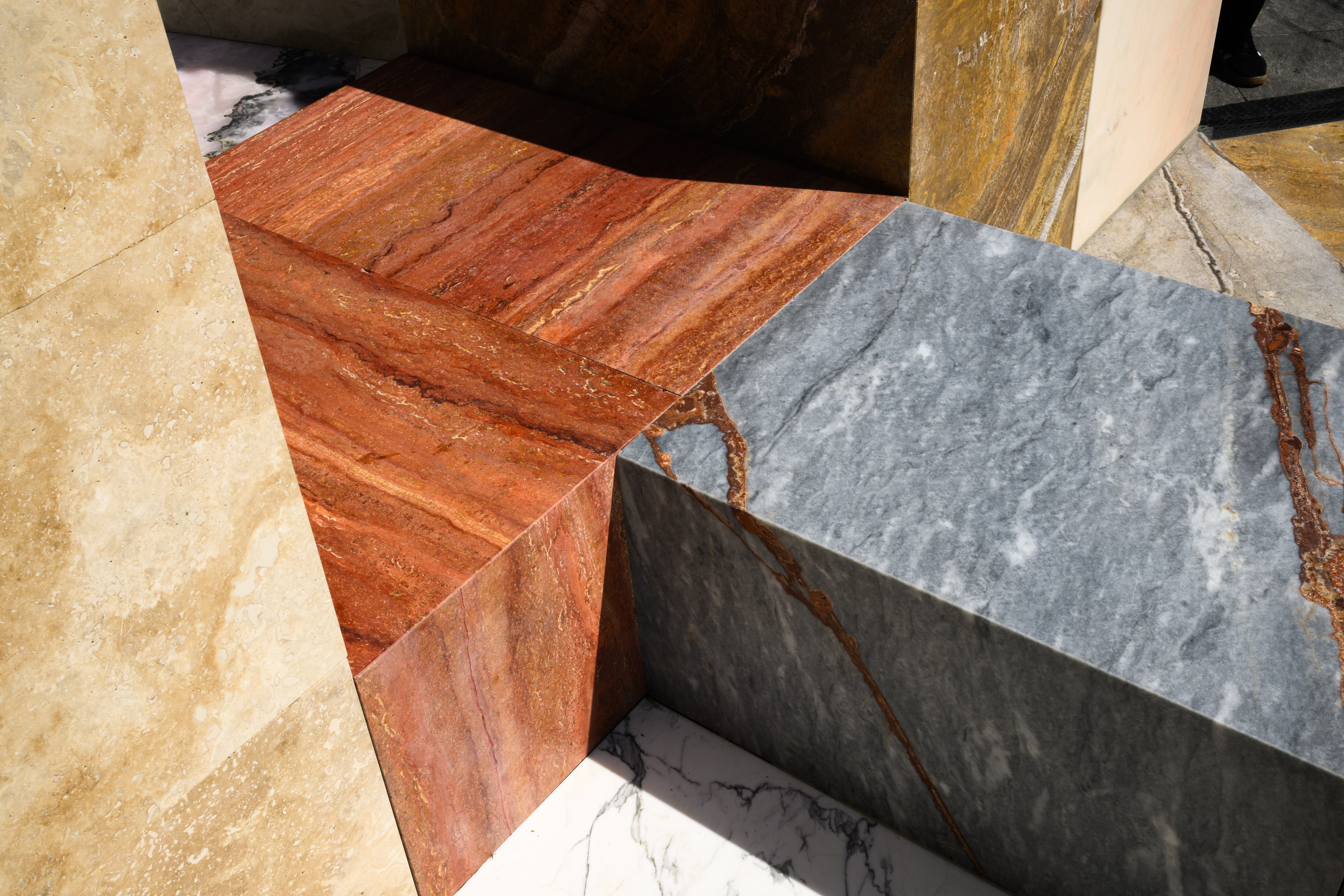 Art installation of different stones making up a public seating area.