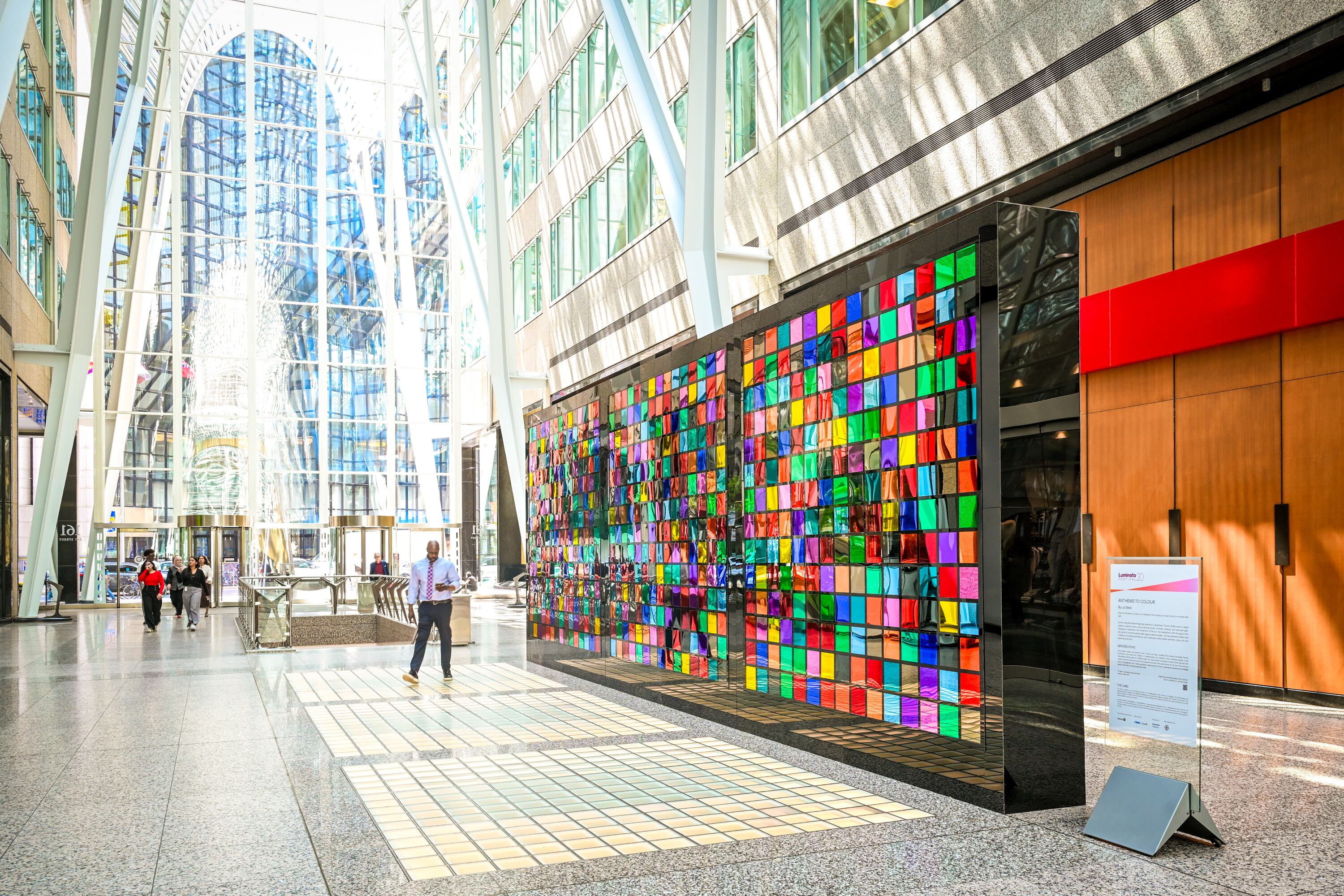 Multicolored glass cubes that make up a rainbow art installation.