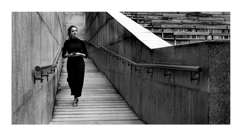 woman walking down stairs black & white