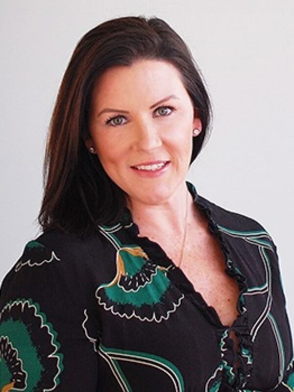 Woman with brown hair and black and green blouse