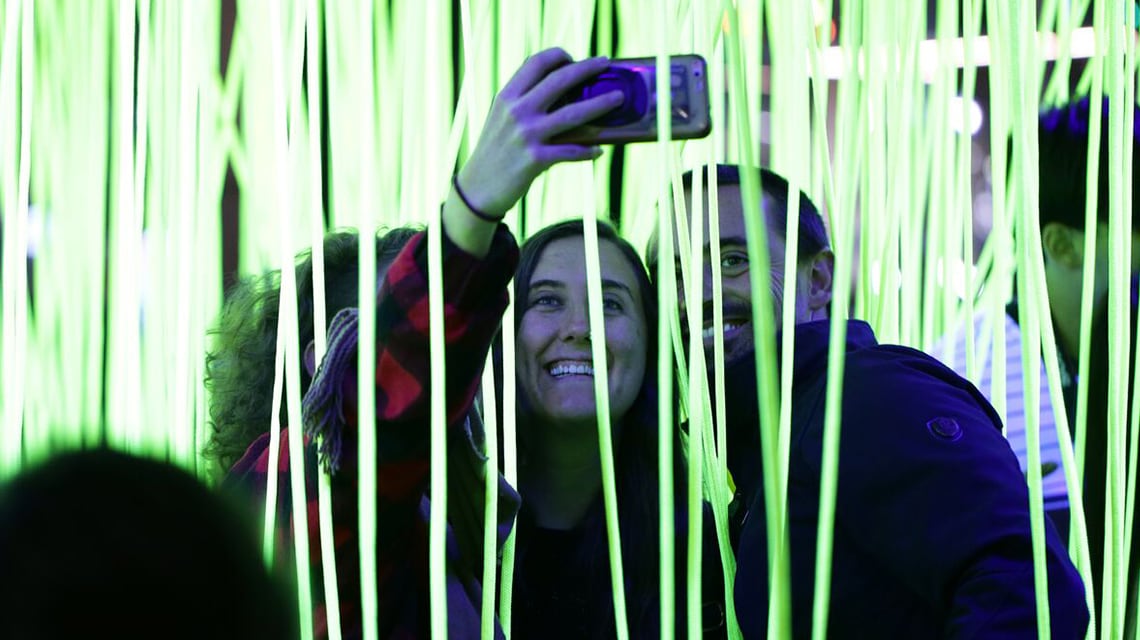 people taking selfie in art exhibit