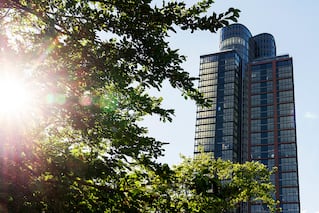 Exterior of Two Blue Slip building in Brooklyn New York with tree and sunlight