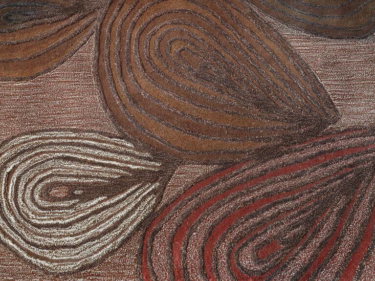 Orange, red yellow and white spiral designs on a rug