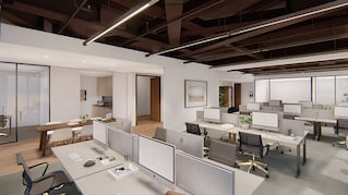 modern office space with grey desk chairs and desks with monitors