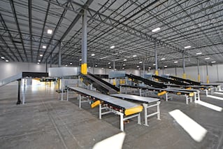 photo of the inside of a warehouse with conveyor belts inside