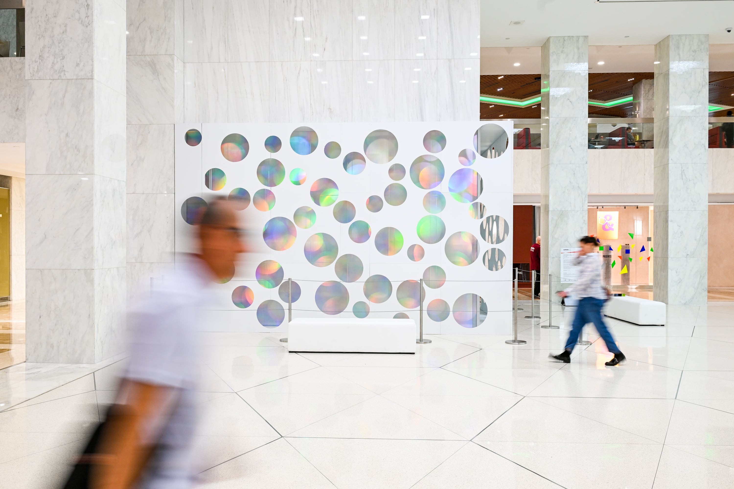 Multicolored glass cubes that make up a rainbow art installation.