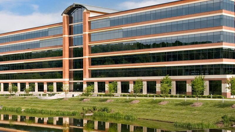 brown office building with lawn