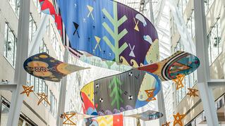 large colorful Tepkik Art installation hanging from ceiling