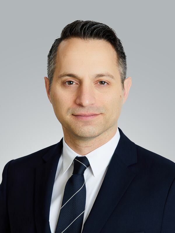 headshot of a man in a suit with tie and white shirt