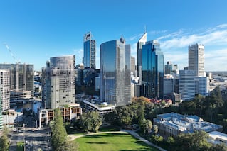 One The Esplanade horizonal view during the day of the tall office building and neighboring office buildings.