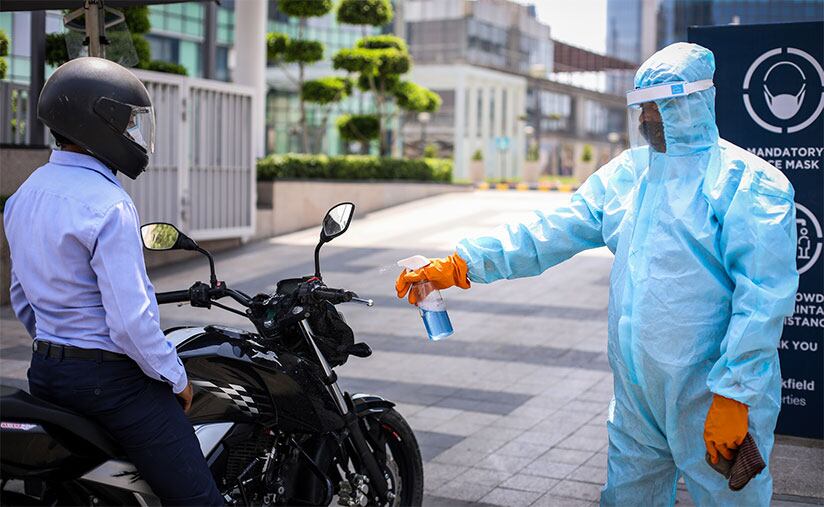 safety worker spraying down motorcycle