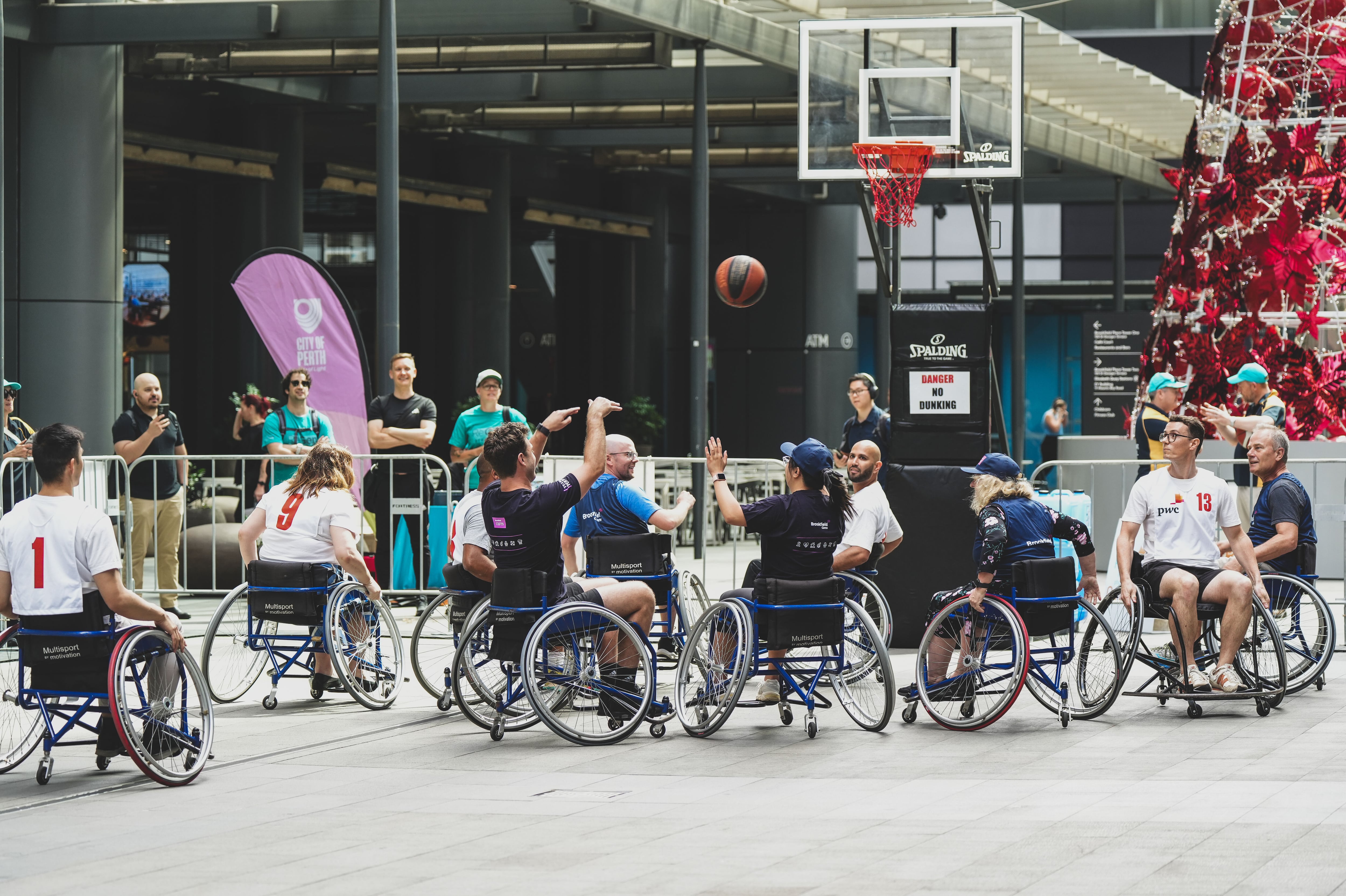 individuals in wheelchairs playing basketball
