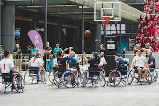 individuals in wheelchairs playing basketball