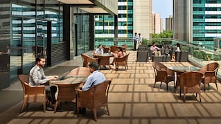 People sitting at tables meeting on roofdeck