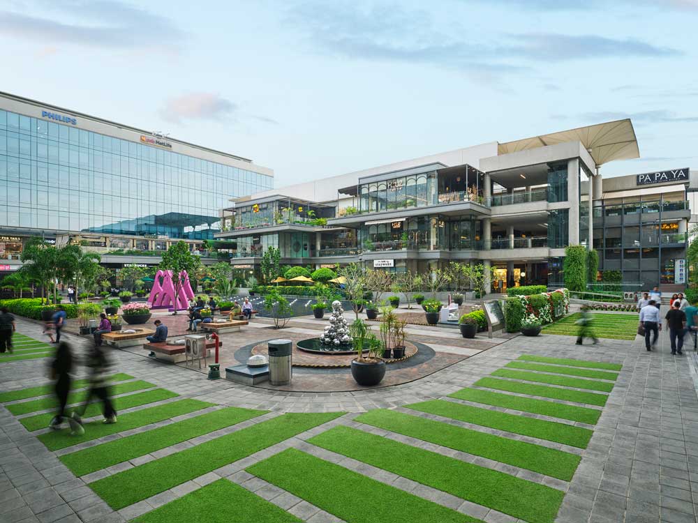 Green space in public common area with people walking throughout