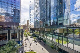 Manhattan West outdoor retail plaza with people.