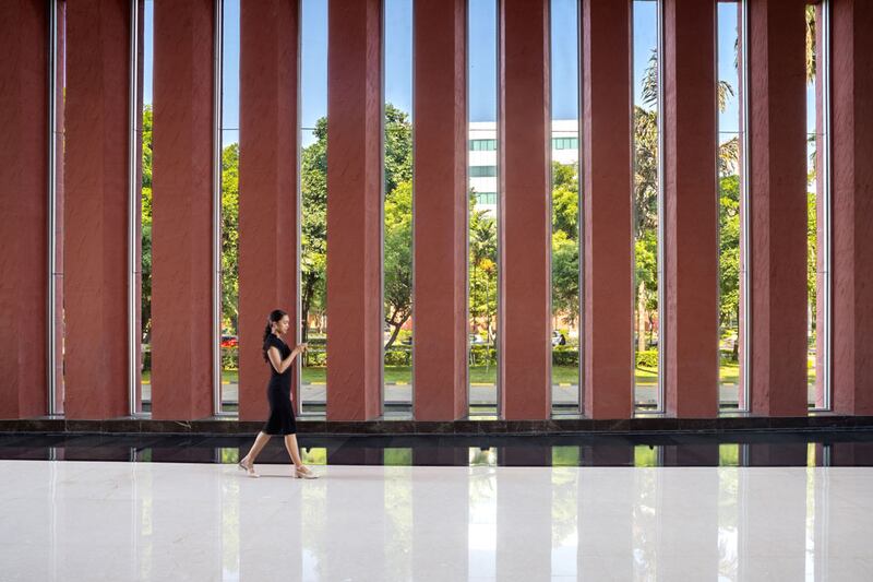 office interior with tall thin windows and woman walking