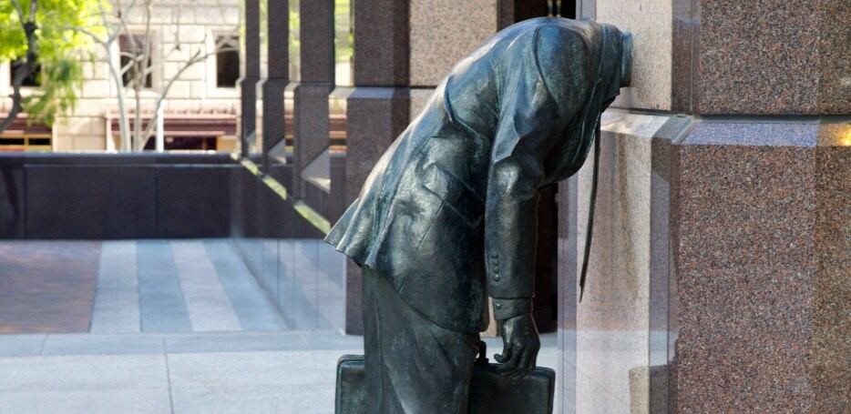 Arts LA man with head stuck in building sculpture