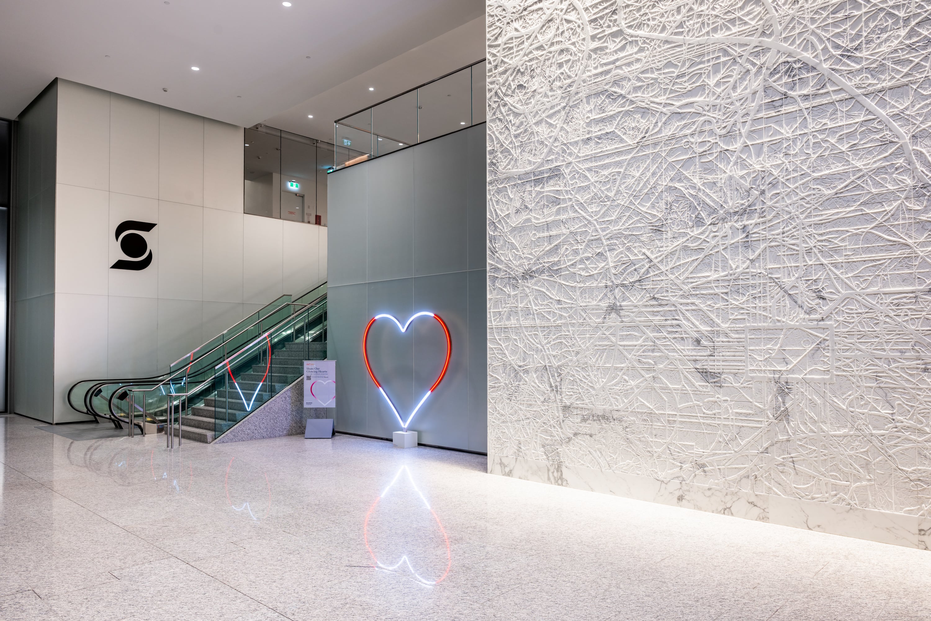 Our Glowing Hearts, 6 foot LED hearts programmed to glow red and white like a Canadian flag in the lobby of office tower.