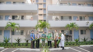 people with plants outside Lilia Waikiki building