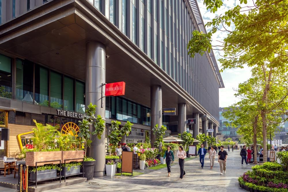 Walkway at retail location with storefronts and people walking by