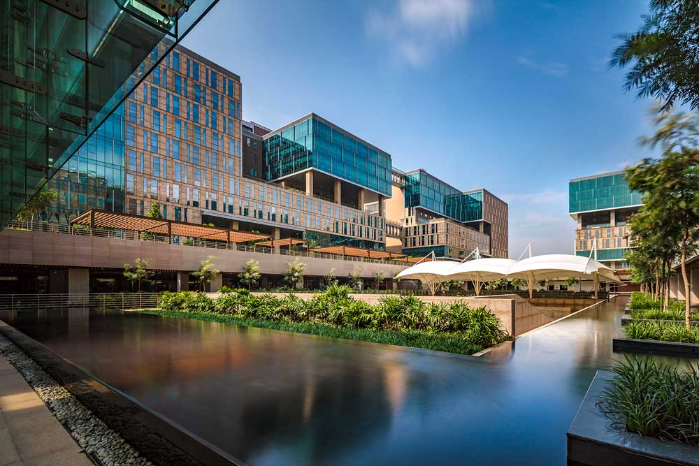 A large reflecting pool in front of an office building.