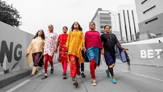 Group of Indian women walking down sidewalk