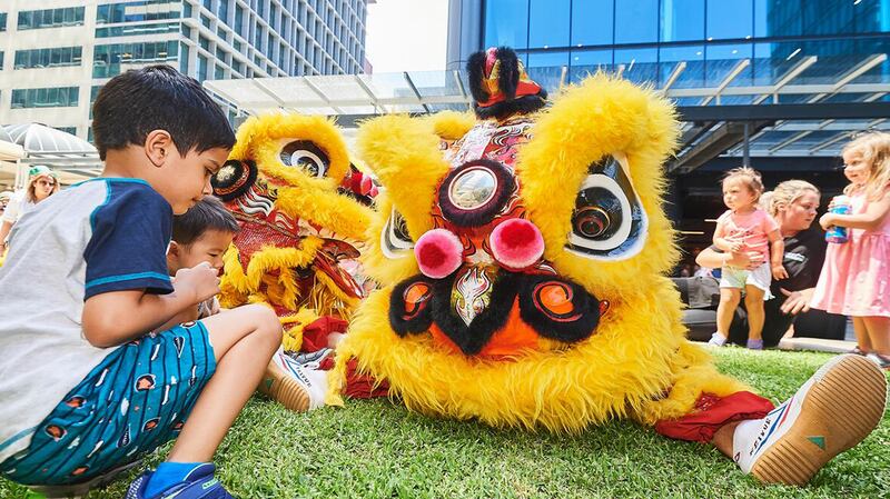 Outside at Brookfield Place Perth with children looking at yellow costume