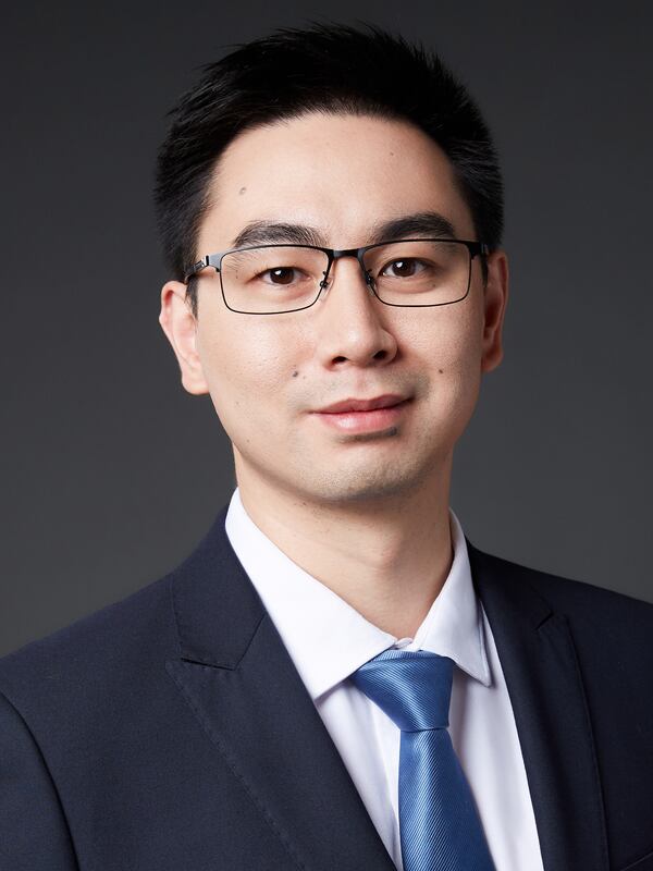 male with navy sport coat, white shirt and blue tie