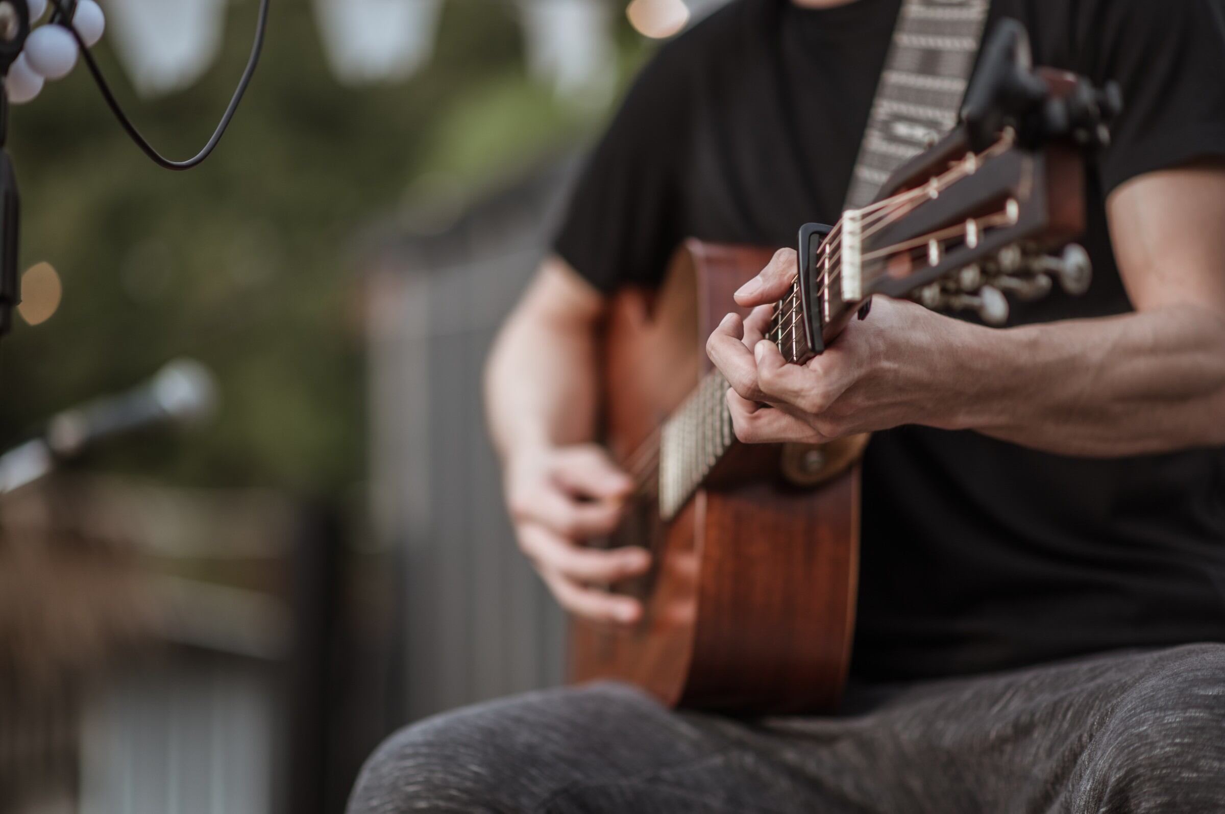 A person playing the guitar as part of Acoustic Nights at One The Esplanade, Perth, Australia