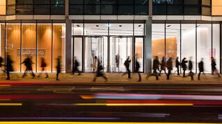 People walking in front of a building at night