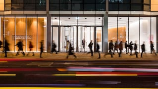 People walking in front of a building at night