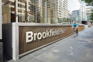 Outdoor sign for Brookfield Place with person on a bike riding by