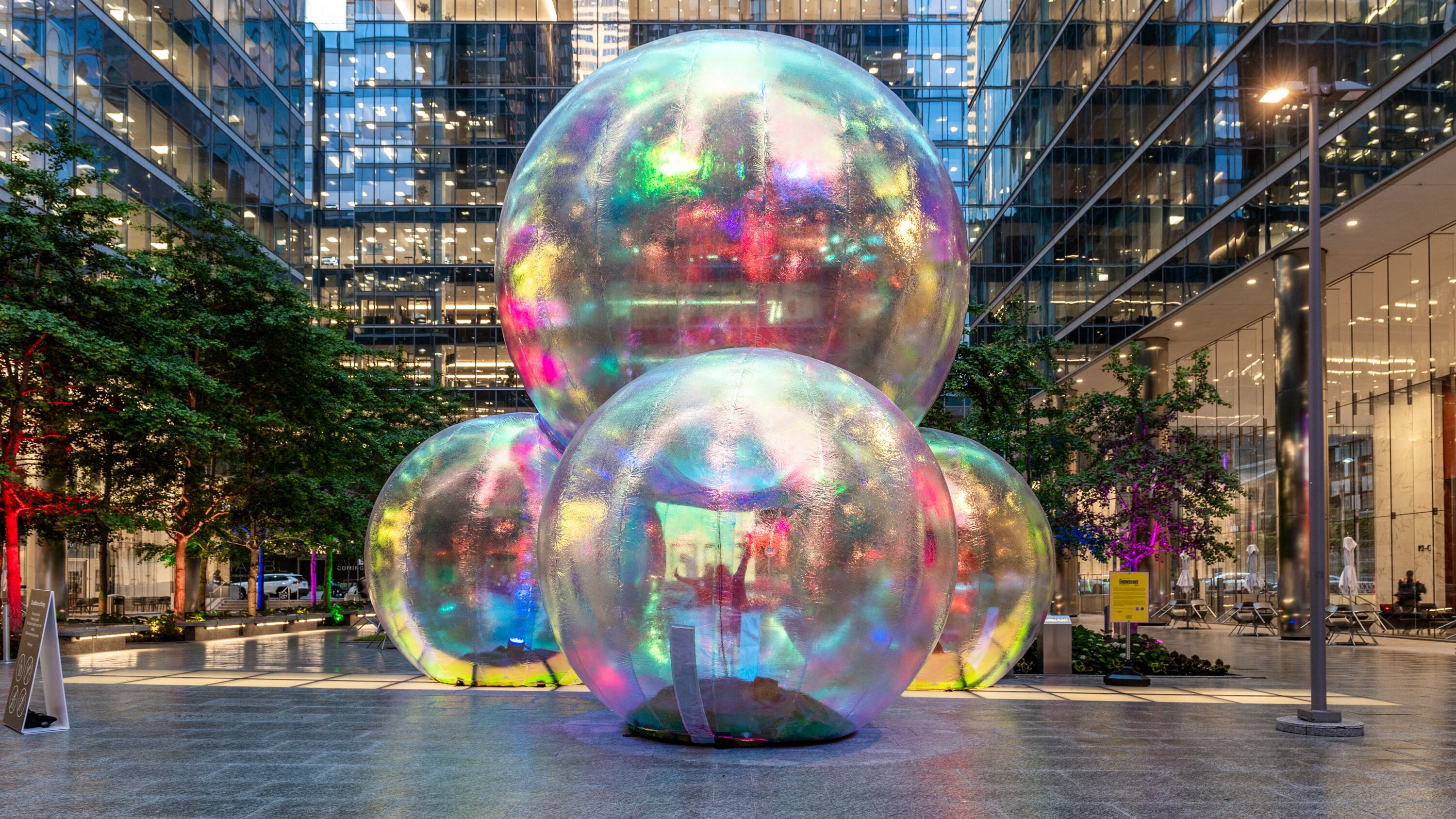 A temporary immersive bubble-tecture in a courtyard at dusk