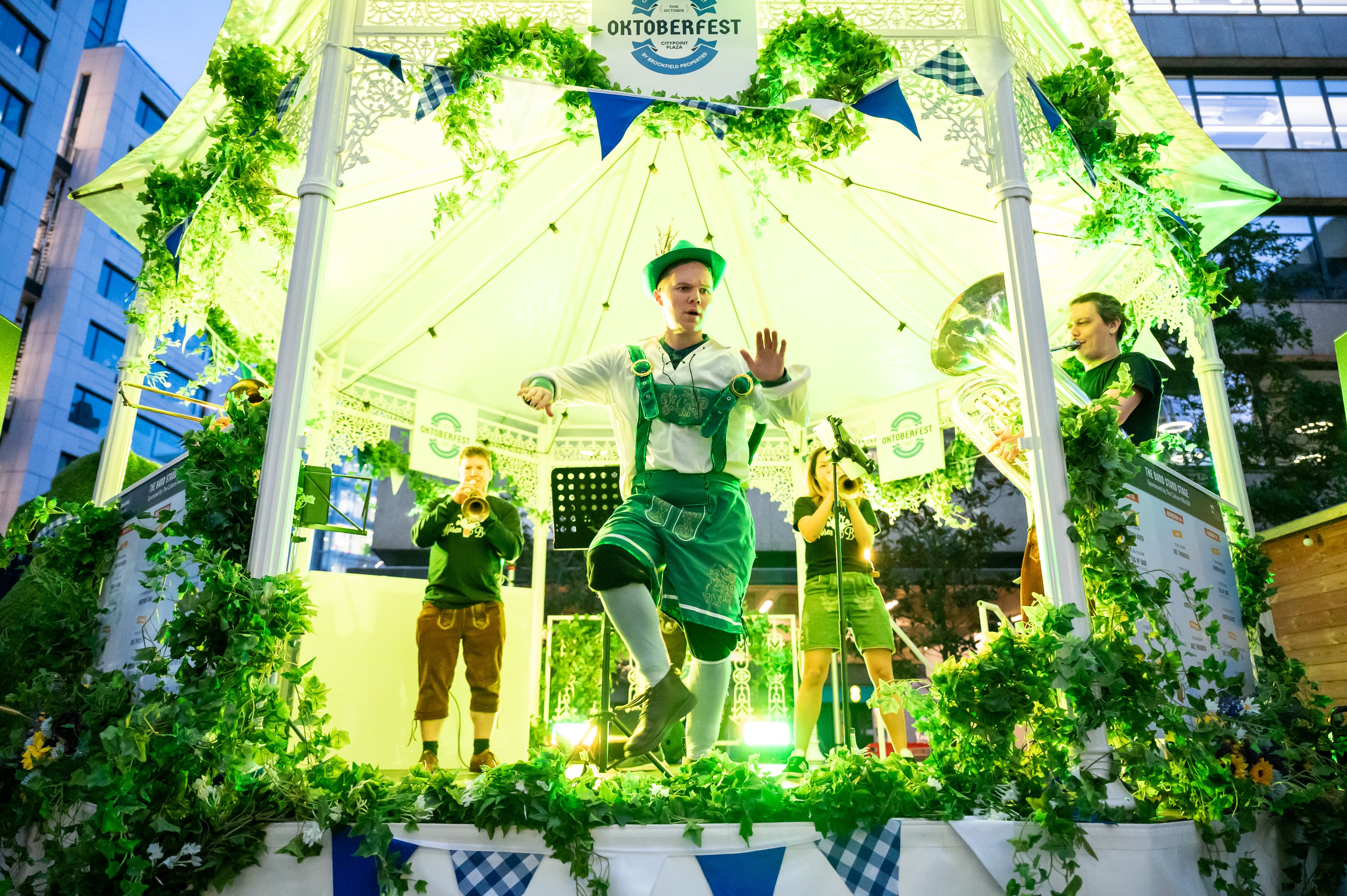 People dancing on a bandstand at Octoberfest at Citypoint.