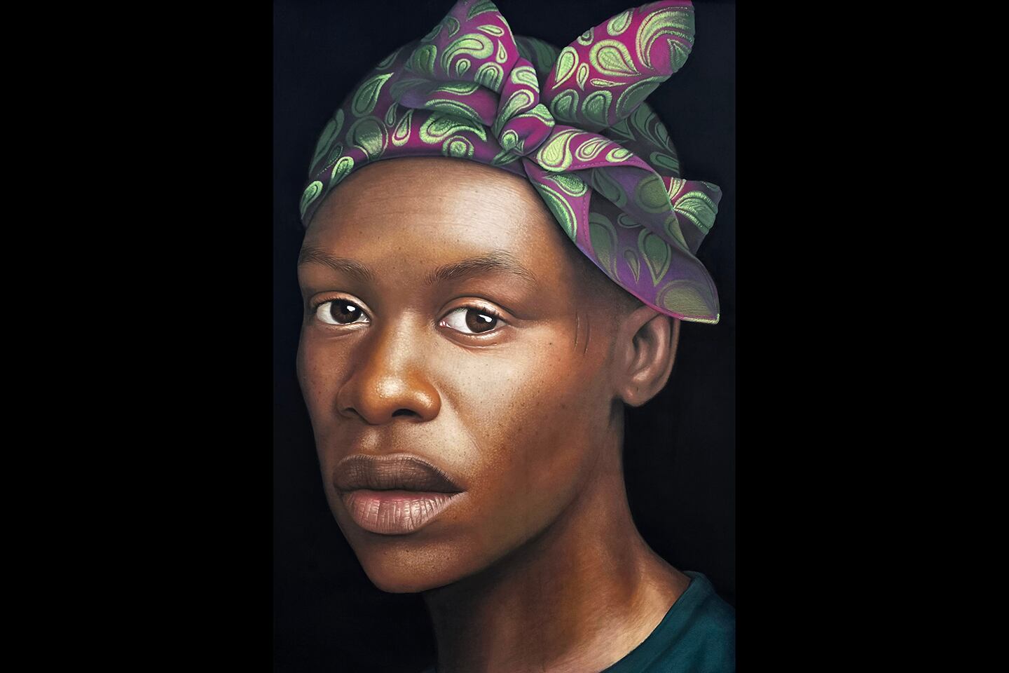 The image is a highly detailed portrait of a person with a serious expression. They have smooth, medium-dark skin and are wearing a colorful headwrap with a vibrant pattern in shades of purple and green. The headwrap is tied in a bow at the top of the head. The background is solid black, which makes the subject stand out prominently. The lighting highlights the natural texture of the skin and the intricate folds of the headwrap fabric, giving the portrait a realistic, almost three-dimensional quality.