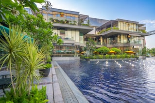 buildings with greenery on left and water in foreground