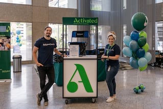 2 people standing at Activated desk