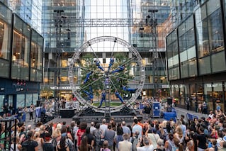 group watching large wheel